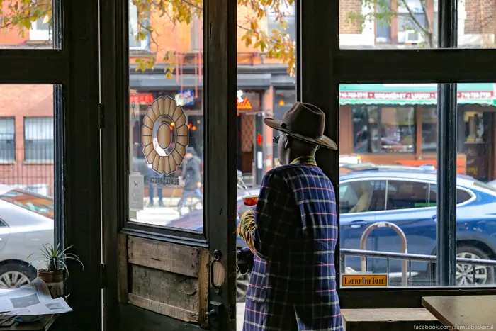 Man leaves coffee shop in Williamsburg